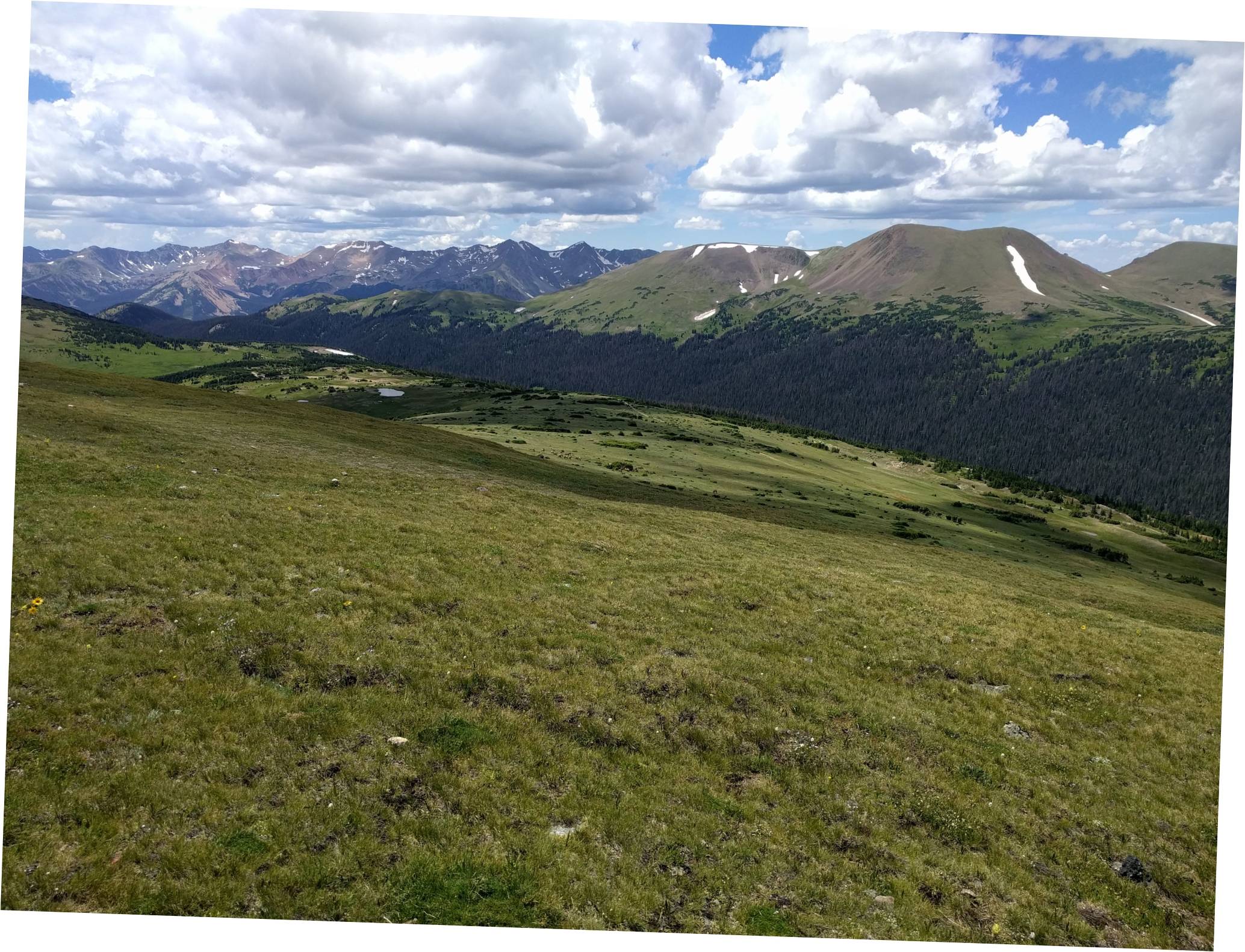 Image: A view of the Ute Trail and an adjacent reservoir from the Gore Range Overlook; there is fifty-odd mule deers grazing on the meadow below that can be spotted in the middle of the picture.