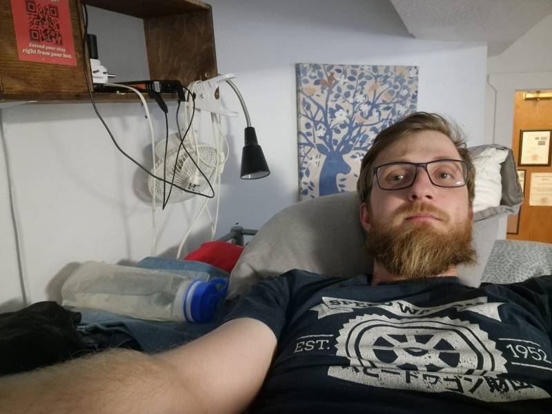 Me on a bunk bed in a mixed dormitory room shared with about ten other travellers