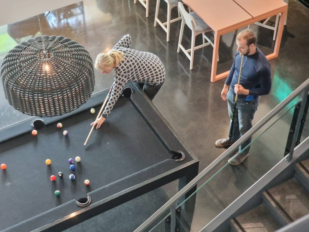 My brother and mom playing pool in the hotel lobby